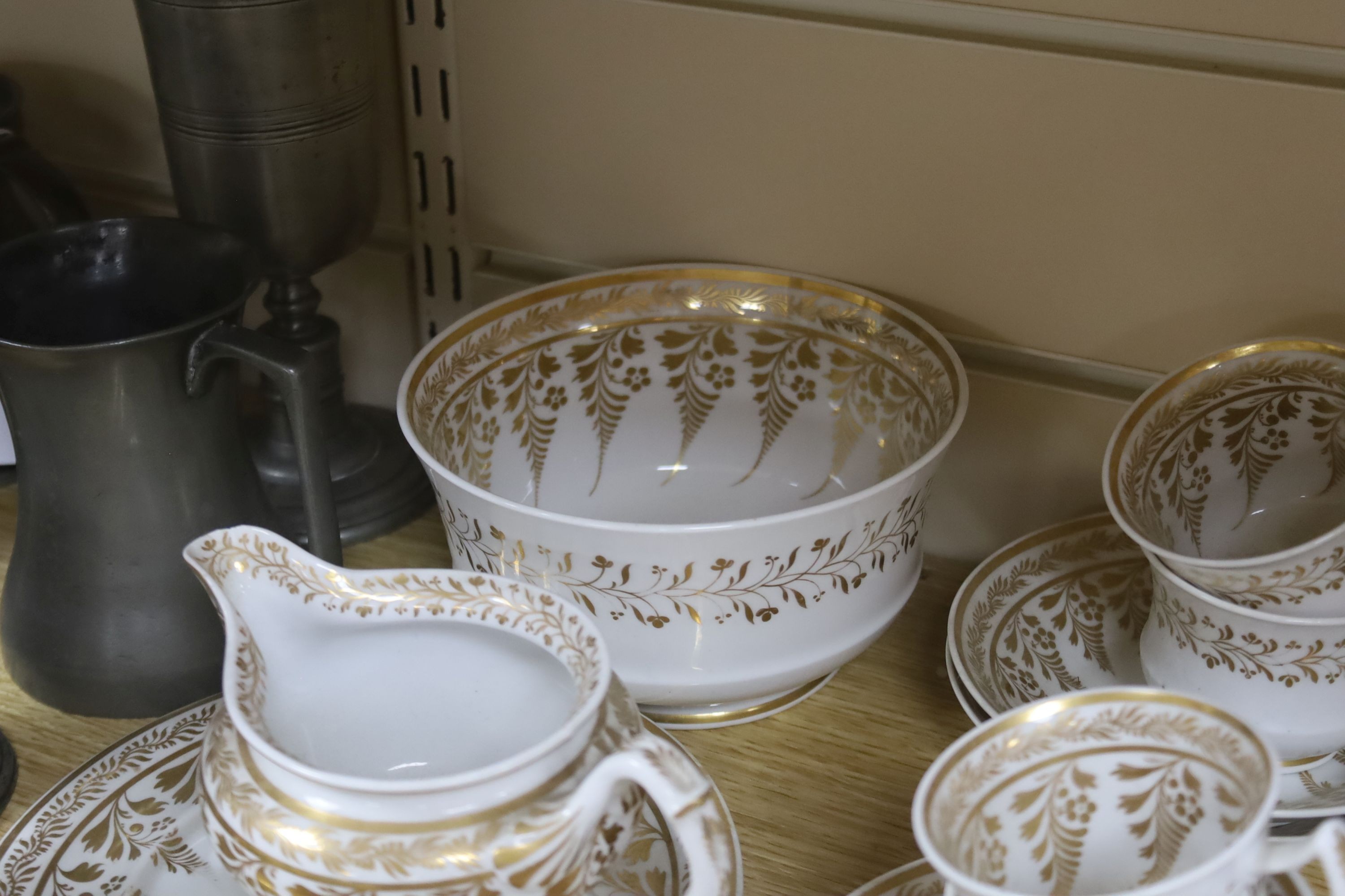 An early 19th century English porcelain gilt decorated part tea and coffee set